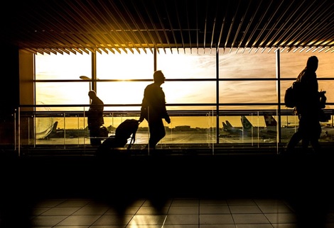 a man is at the airport leaving for a business trip