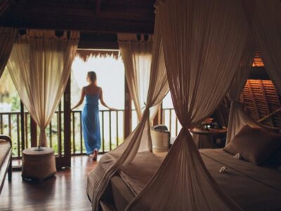A woman standing at the balcony enjoying her luxury vacation