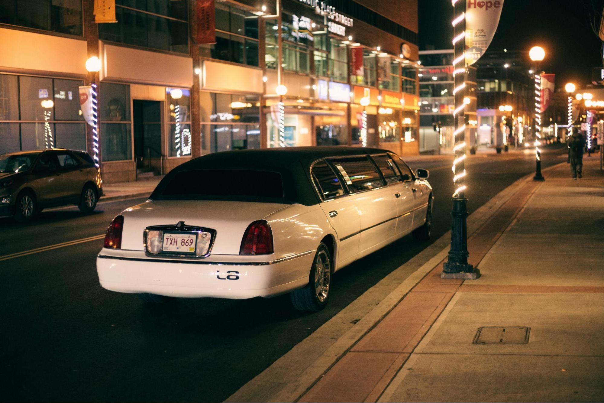A limousine luxury car service parked on a road